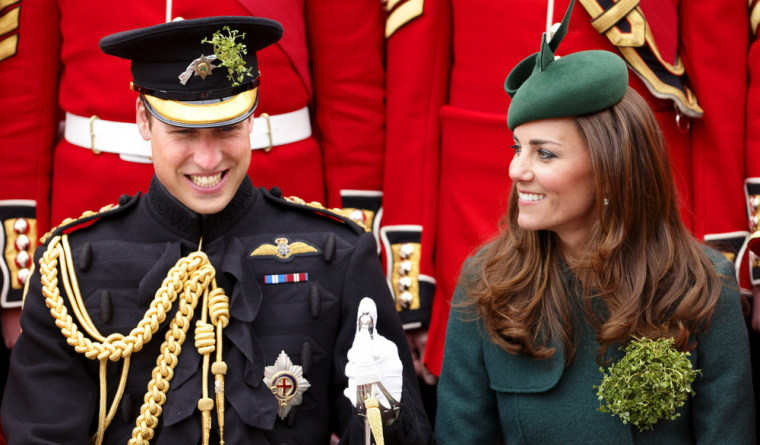 The Duke and Duchess of Cambridge share a laugh as they pose for a group photograph with soldiers of the Irish Guards.