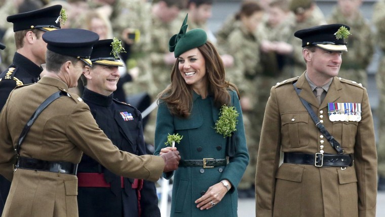 Britain's Catherine, Duchess of Cambridge presents shamrocks to officers and guardsmen of the 1st Battalion Irish Guards during a visit with her husba...