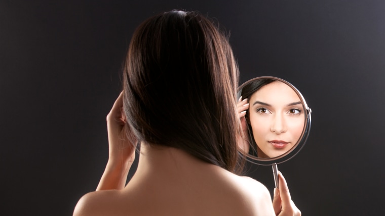 Woman looking in the mirror