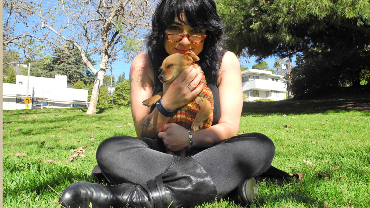 C.J. and her pet, dressed in her knitted design, share a cuddle in Los Angeles.