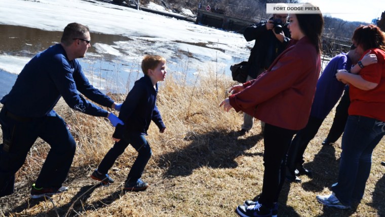Rescuers reunited the boys with their mother and sister on the banks of the Des Moines River.