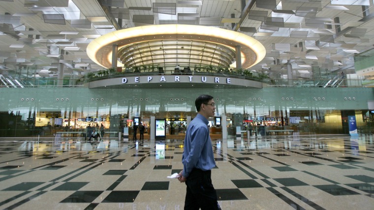 Image: A man walks past the departure gate in Singapore's Changi Airport on Jan. 9, 2008.