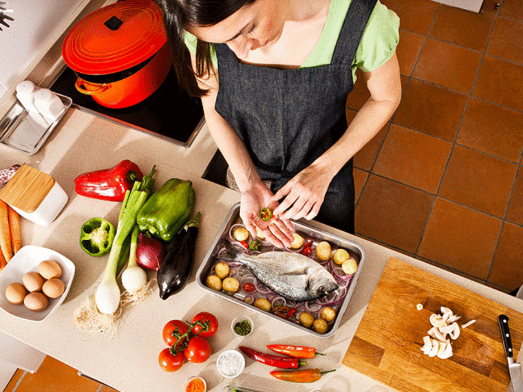 woman cooking dinner - 6 Tips to Get Dinner on the Table Faster