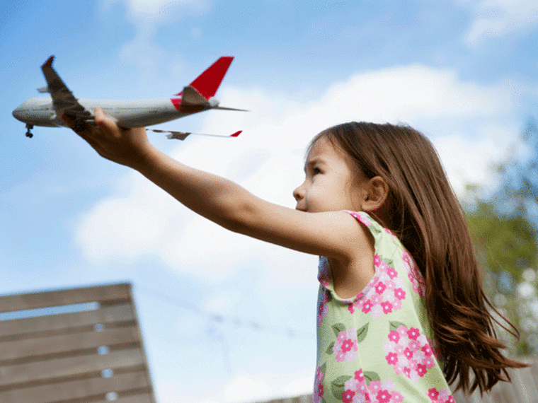 Girl playing with toy plane -- Toys R Us Goes Gender Neutral