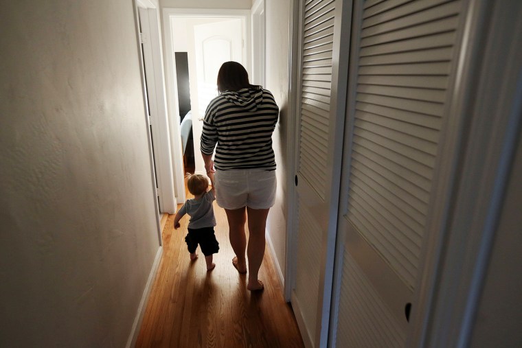 Kelly Hofstra walks with her son, Mason,1, to take a bath at their home in San Diego, Calif. Kelly and her husband, Darren, both work full time and wish they had more time to spend with Mason.