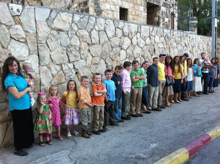 Take time to encourage: Michelle Duggar with her 19 children (and some grandchildren, and daughter-in-law)!