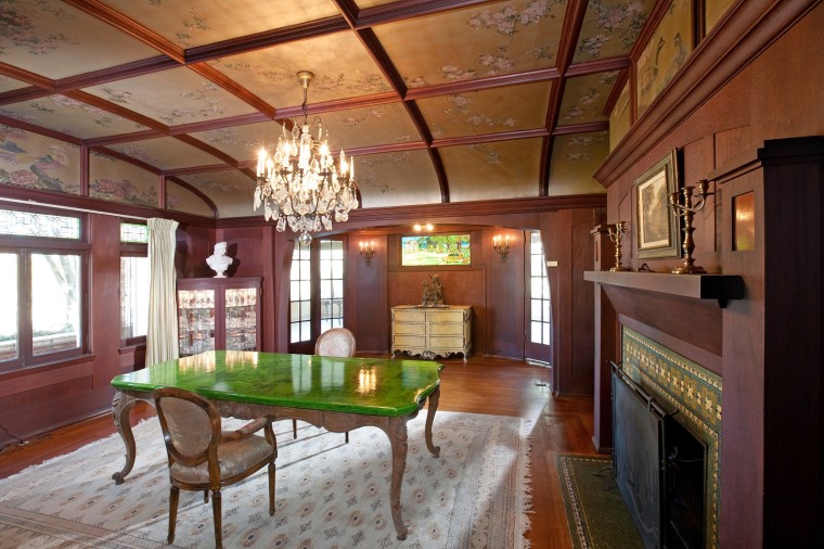 The formal dining room has hand-painted ceilings in gold and silver leaf.