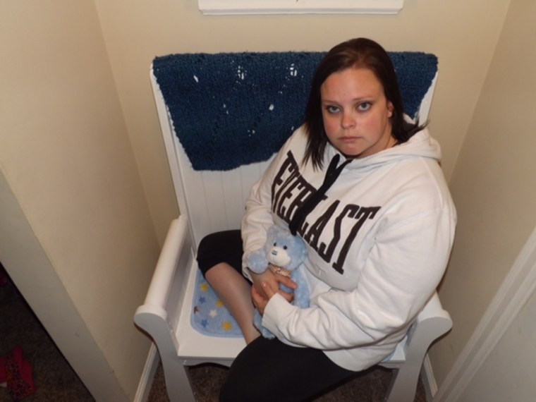 Valarie Watts sits on the memorial bench made from the crib she bought for her stillborn son, Noah.