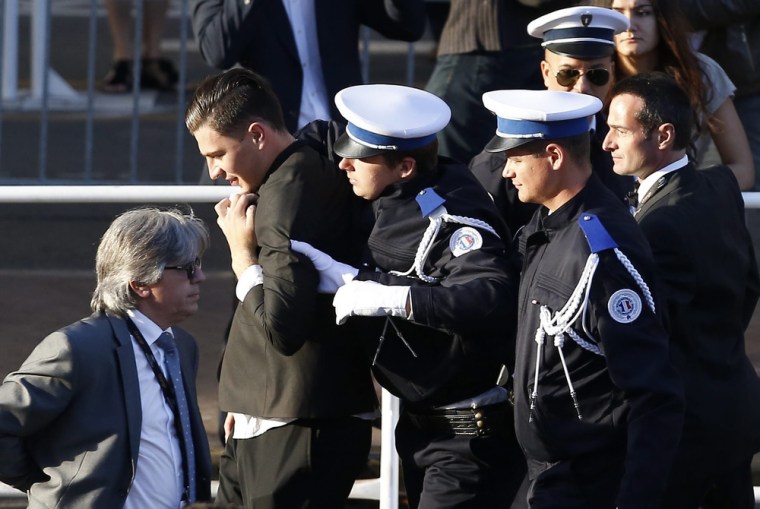 IMAGE: Security guards take man away