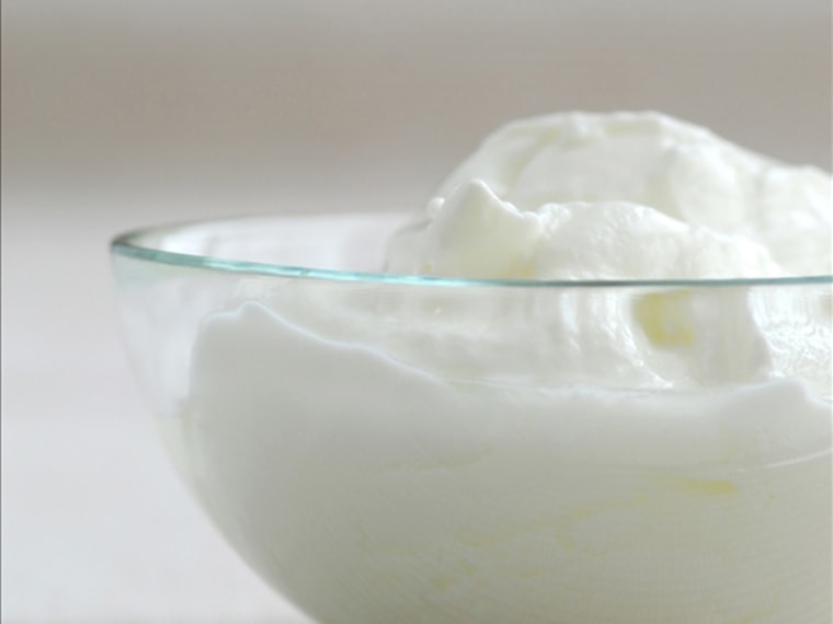 Fresh yogurt served in a clear glass bowl