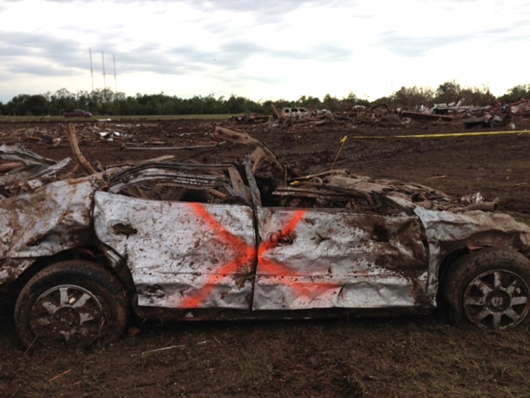 The tornado killed 24 people. The orange \"X\" on this car indicates no bodies were found inside.