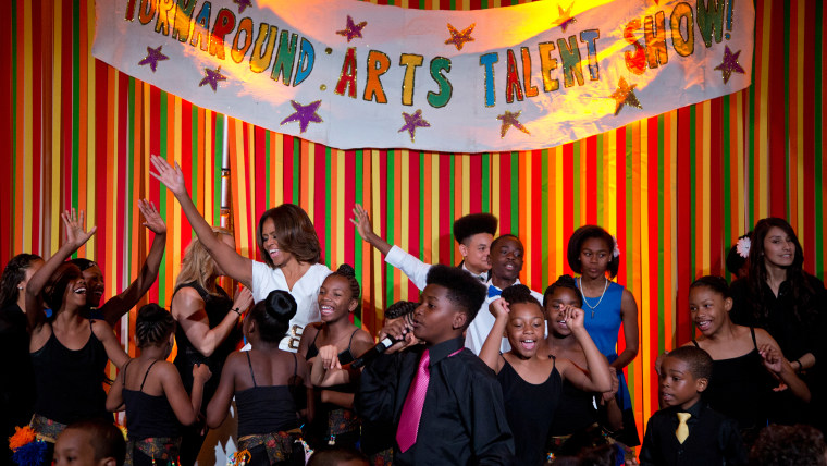 First lady Michelle Obama dances on stage with student performers as she and the President’s Committee on the Arts and the Humanities (PCAH) host the ...