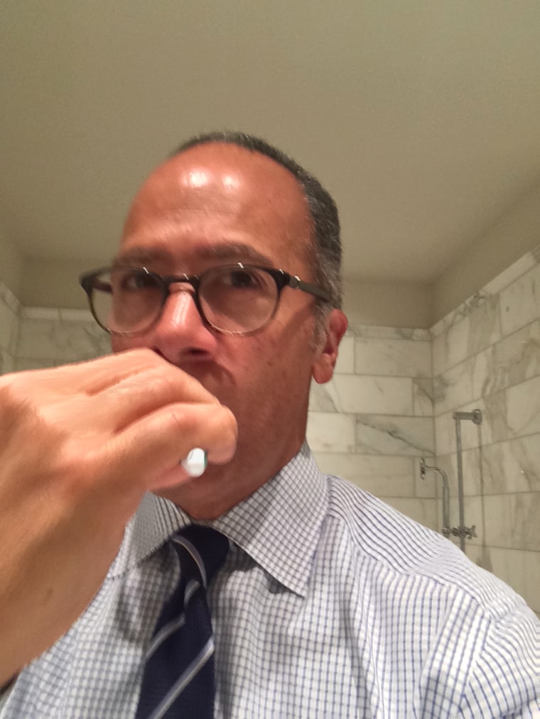 Lester Holt brushes his teeth.