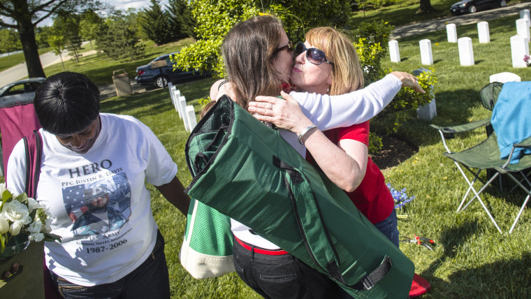 Beth Belle hugs Gina Barnhurst near their sons graves at Arlington National Cemetery in Arlington, Virginia on May 18, 2014.