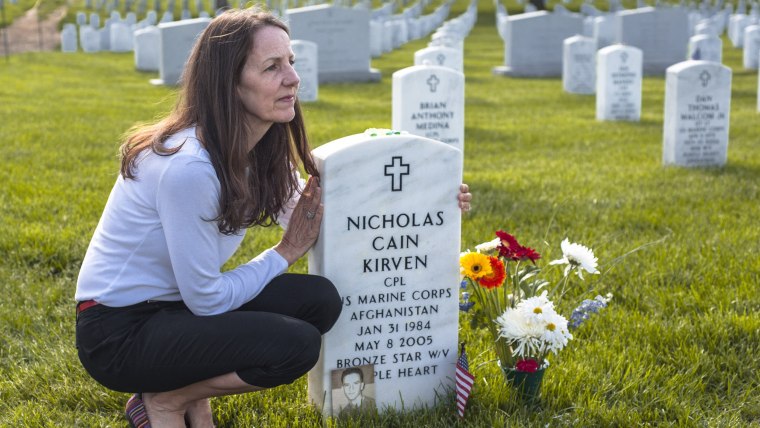 Beth Belle poses for a portrait next to her son Nicholas Cain Kirven's grave at Arlington National Cemetery in Arlington, Virginia on May 18, 2014.