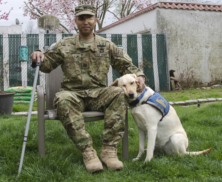 Retired U.S. Army Capt. James Van Thach gets some love from his service dog, Liz.