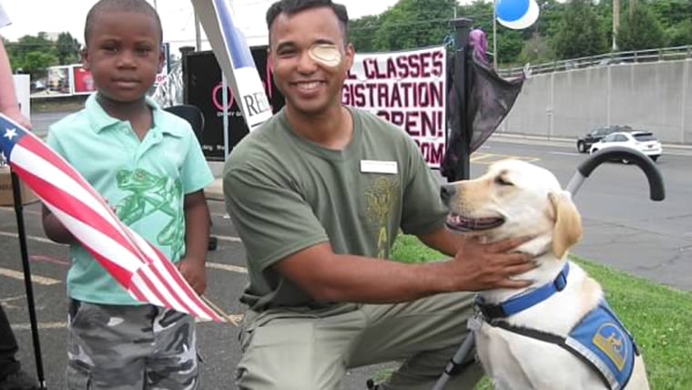 At this 2012 Canine Companions event in Long Island, N.Y., retired Capt. James Van Thach was honored for his military service. Thach's service dog Liz stayed by him during the event.
