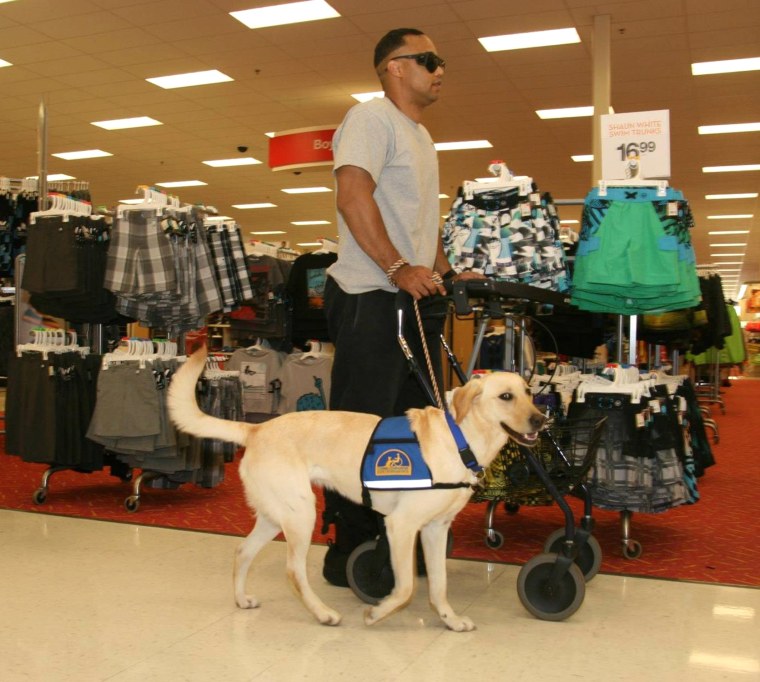 Retired U.S. Army Capt. James Van Thach shopping with the help of his service dog, Liz.