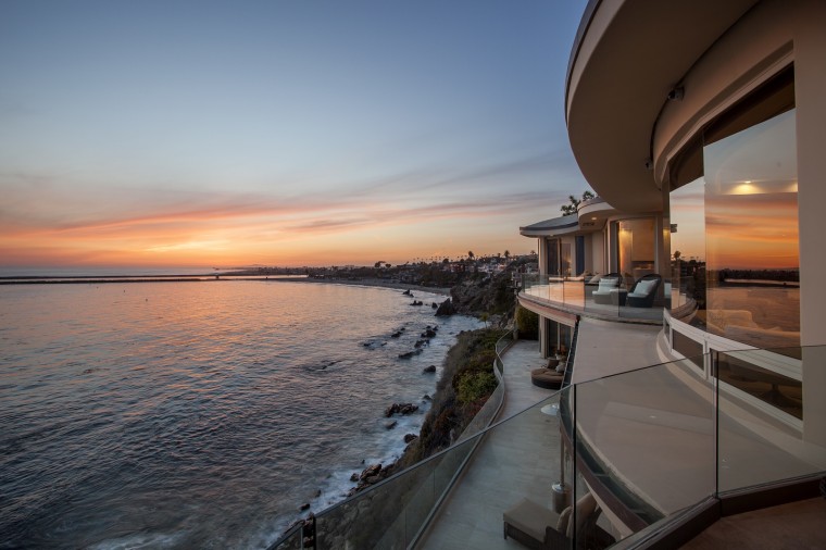 The custom-designed oceanview home features more than 180-degree views out the front wall of glass.
