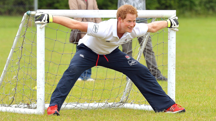 Britain's Prince Harry prepares to stop a penalty, during a short soccer kick about at the Inspire Suffolk centre for young people in Ipswich, eastern...