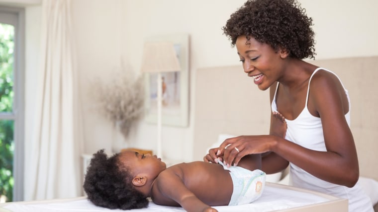 Happy mother with baby girl on changing table at home in the bedroom; Shutterstock ID 207022615; PO: TODAY.com
