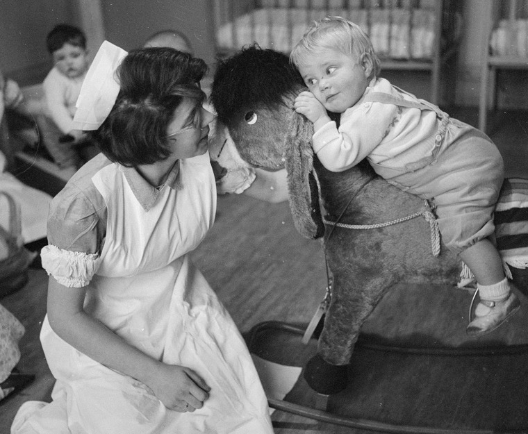 February 1962:  A student nurse supervises a toddler on a rocking horse at Princess Christian College for Nursery Nurses in Manchester.  (Photo by Joh...