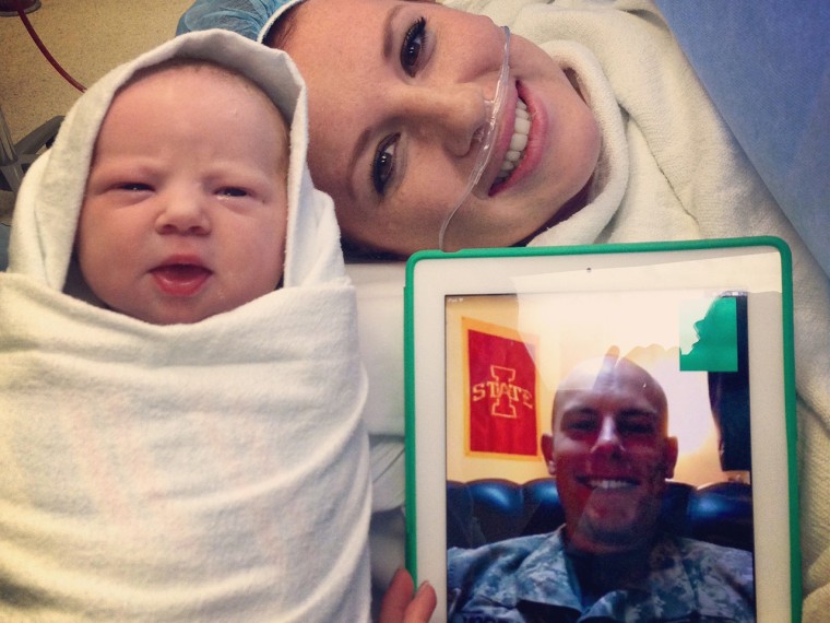 Janae Vorrath and the couple's newborn daughter, Charlotte, give a smile to proud father John Vorrath, who watched the birth on his iPad while deployed with the Iowa National Guard in the Middle East.