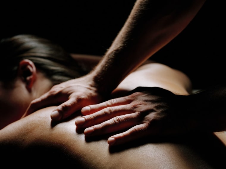 Young woman recieving back massage at spa