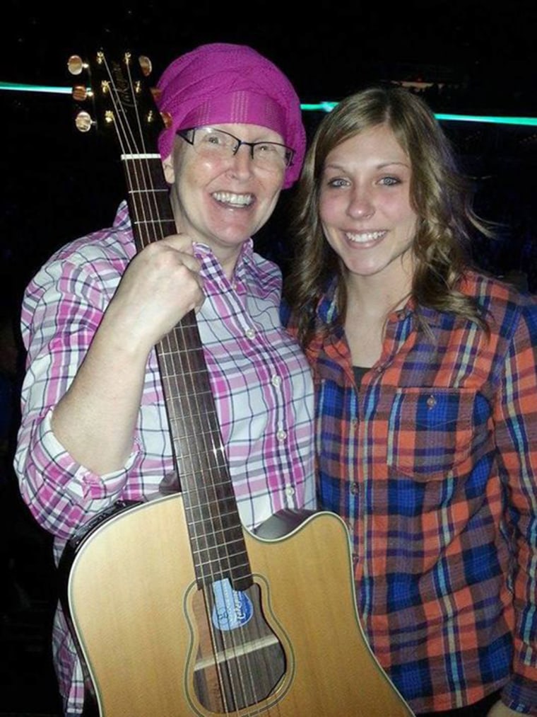 Teresa Shaw poses with her new guitar, a present from Garth Brooks.