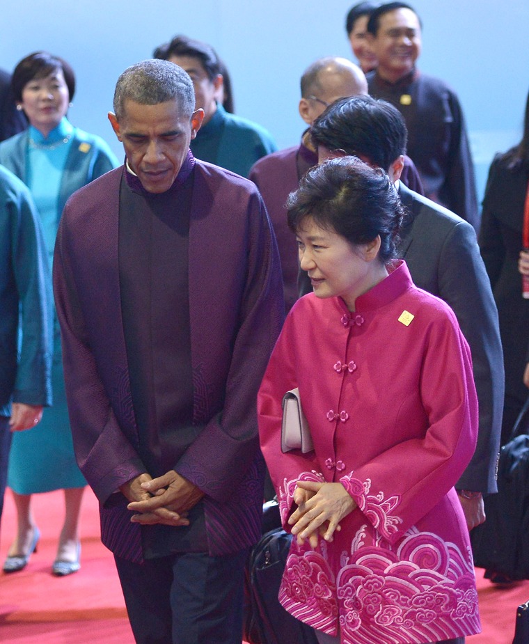 US President Barack Obama (L) walks with South Korea's President Park Geun-hye (R) after posing for the APEC family photo at the Beijing National Aqua...