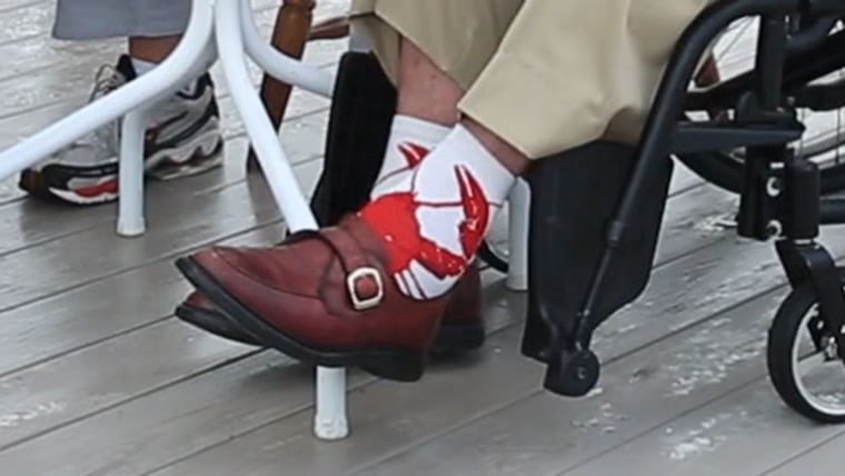 The elder President Bush shows off his lobster socks.