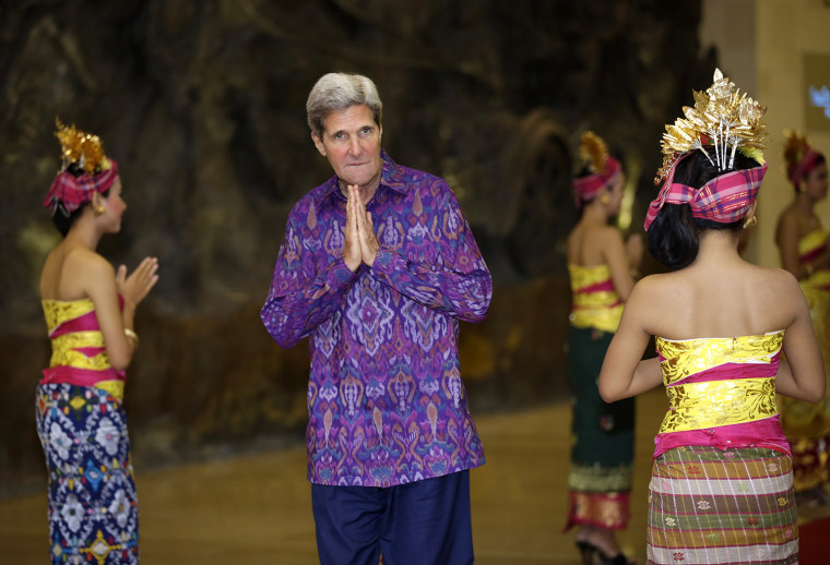 US Secretary of State John Kerry, wearing an \"endek,\" a traditional Balinese woven fabric, poses upon arrival for a gala dinner hosted for the leaders...