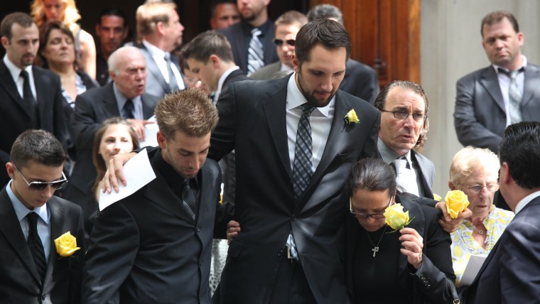 Boyfriend Ryan Anderson and the mother of former \"Bachelor\" contestant Gia Allemand attend her funeral on August 22, 2013 in New York.