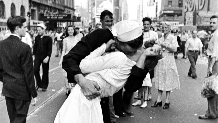 As pedestrians watch, an American sailor passionately kisses a white-uniformed nurse in Times Square to celebrate the long awaited-victory over Japan....