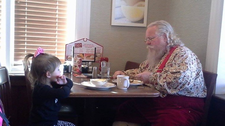 Little Gracie thought that Santa might be lonely, so she pulled up a chair to keep him company.