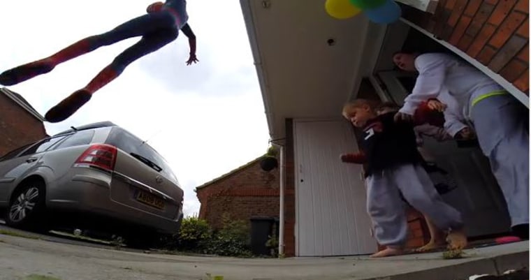 As Jayden takes a cautious step out his front door, boom! His hero, Spider-Man, drops from the sky. (Well, it's dad in a suit leaping from the second floor, but Jayden doesn't know that.)