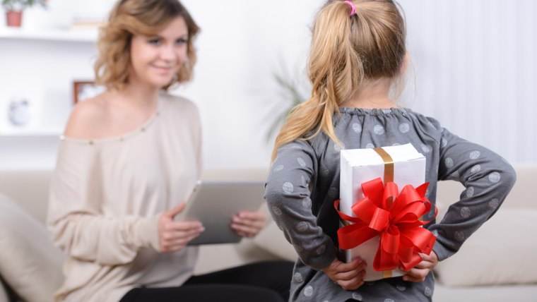 Little beautiful pretty girl giving a gift to her happy mother - indoors; Shutterstock ID 197392076; PO: TODAY.com