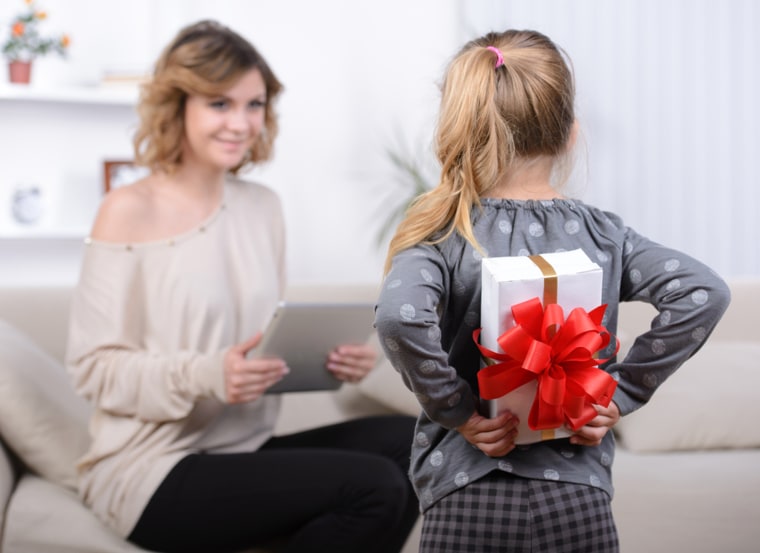 Little beautiful pretty girl giving a gift to her happy mother - indoors; Shutterstock ID 197392076; PO: TODAY.com