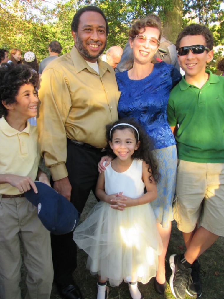 Alina Adams with her husband and three children. While some white parents of mixed-race children hope their children are light-skinned so they can avoid racism, Adams hopes just the opposite.