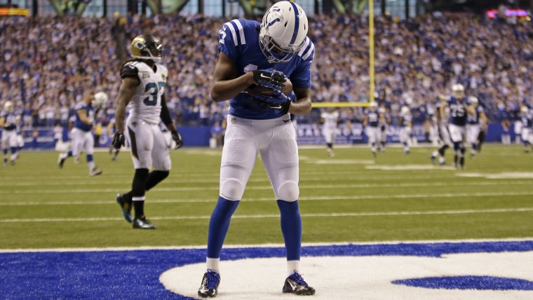 Indianapolis Colts wide receiver T.Y. Hilton (13) cradles the football after a touchdown, in honor of his baby daughter born that day.