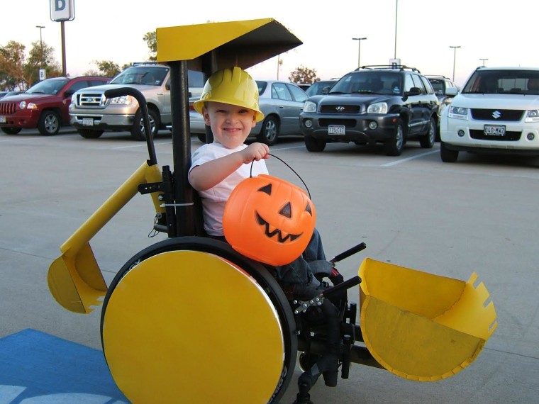 Caleb McLelland at age 3, all smiles as he gets ready to scoop up some Halloween candy in his sweet ride.