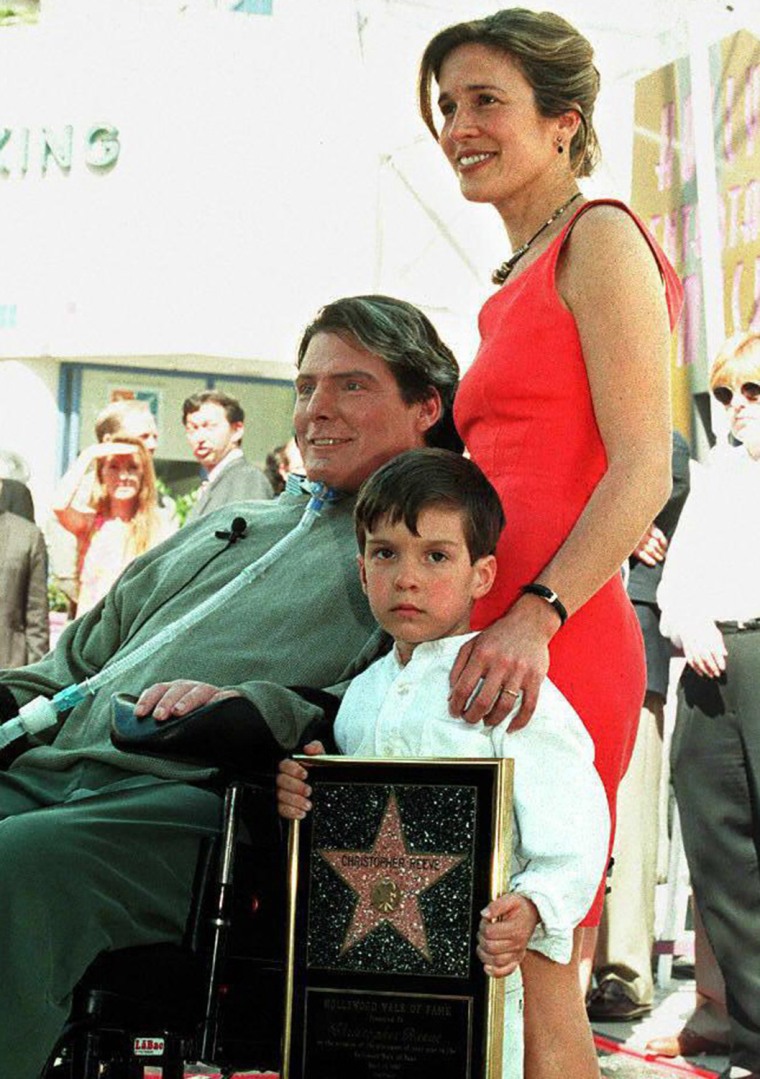 LOS ANGELES, UNITED STATES:  Actor-Director Christopher Reeve poses for journalists with his wife, Dana, and their son, Will, after being honored with...