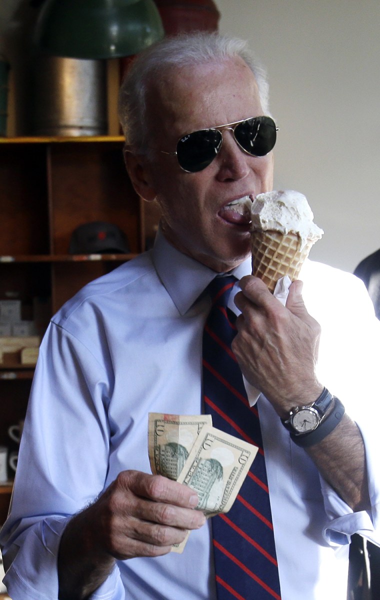 Vice President Joe Biden, right, gets ready to pay for an ice cream cone after a campaign rally for U.S. Sen.  Jeff Merkley in Portland, Ore., Wednesd...