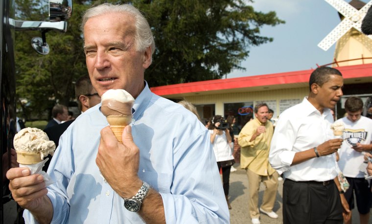 US vice presidential nominee Senator Joe Biden (L) and Democratic presidential nominee Senator Barack Obama (R) enjoy ice cream cones as they speak wi...