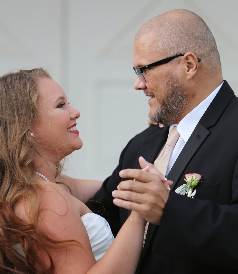 Kaitlin Peters, 21, dances with her dad.