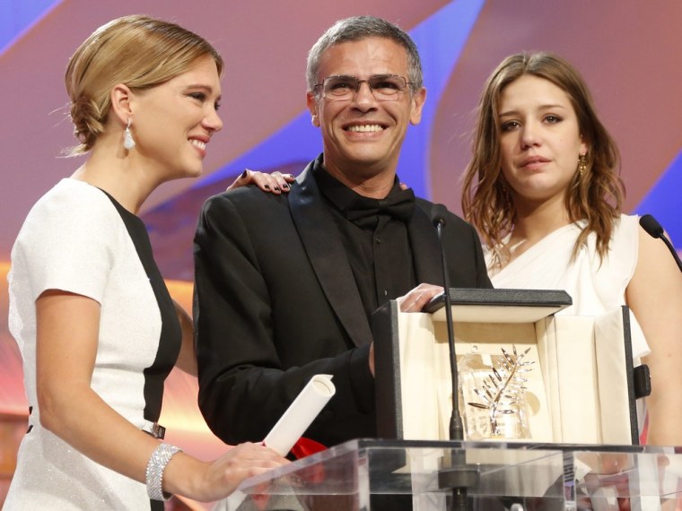 Adele Exarchopoulos, Lea Seydoux and Abdellatif Kechiche stand on stage after receiving the Palme d'Or award for 'La Vie d'Adele' (Blue is the Warmest Color).