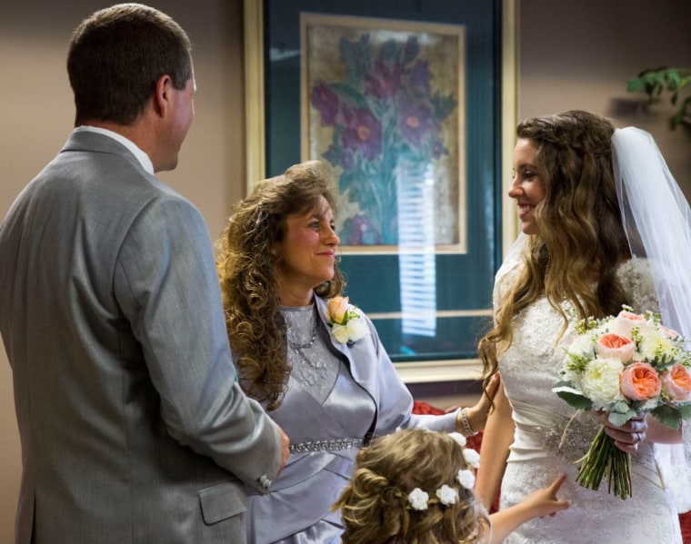 Jill with her mother Michelle and father Jim Bob at her June wedding.