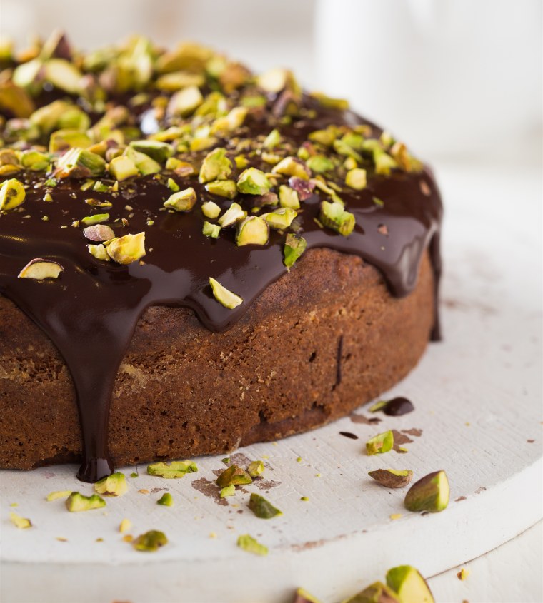 Dark chocolate cake with cardamom, covered with pistachio and chocolate ganache