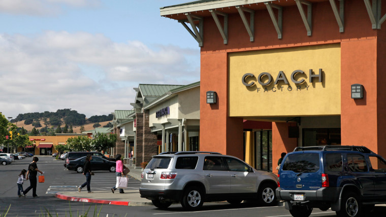 In this photo taken on June 11, 2009, a group of people make their way toward stores at the Napa Premium Outlets in Napa, Calif.
