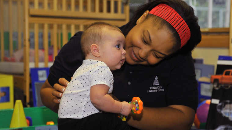FREDERICK, MD - SEPTEMBER 30:  Nikia Crawford interracts with an infant before Laura DeBouchel received the Knowledge Universe Early Childhood Educato...